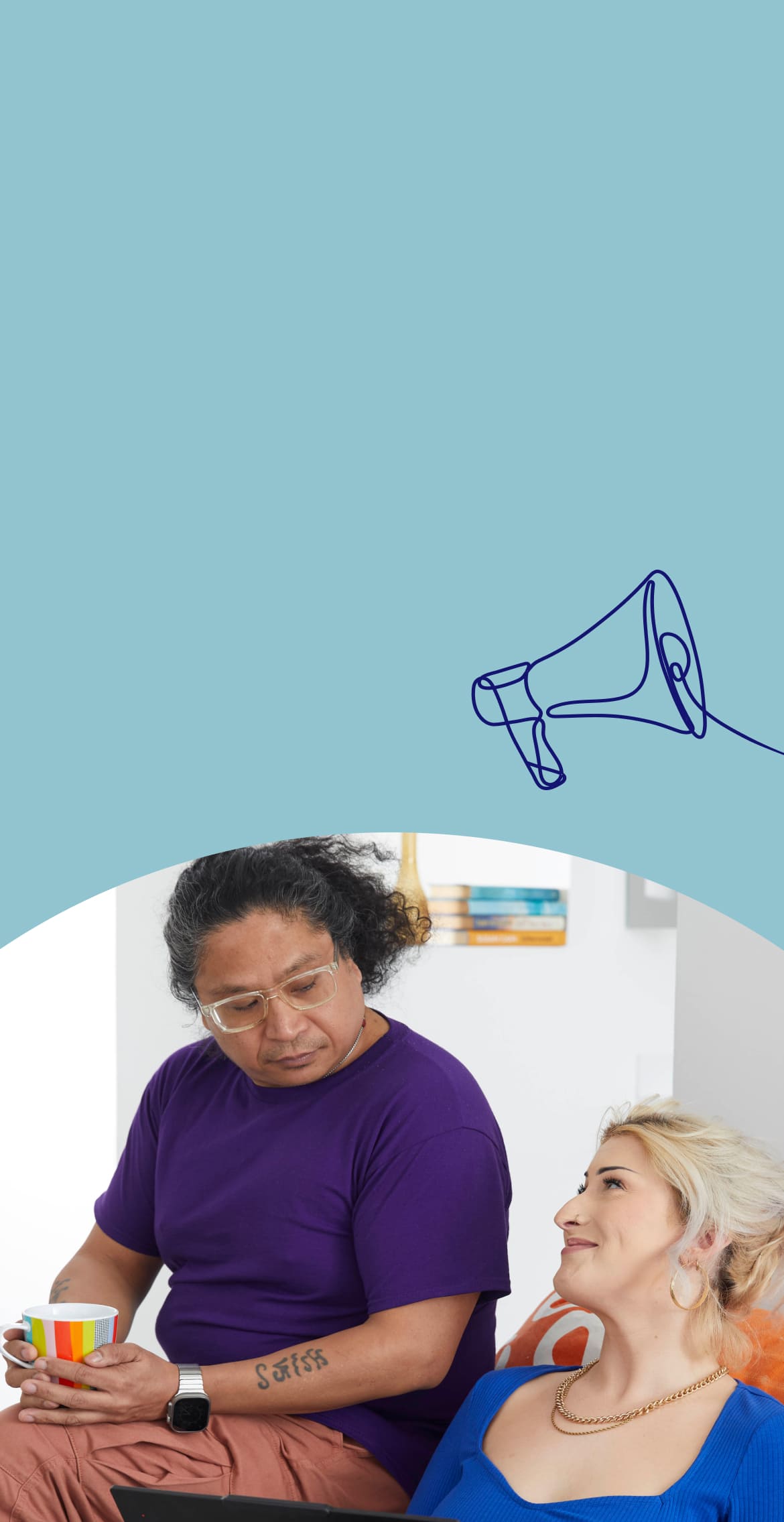 Man drinking tea while smiling woman works on laptop